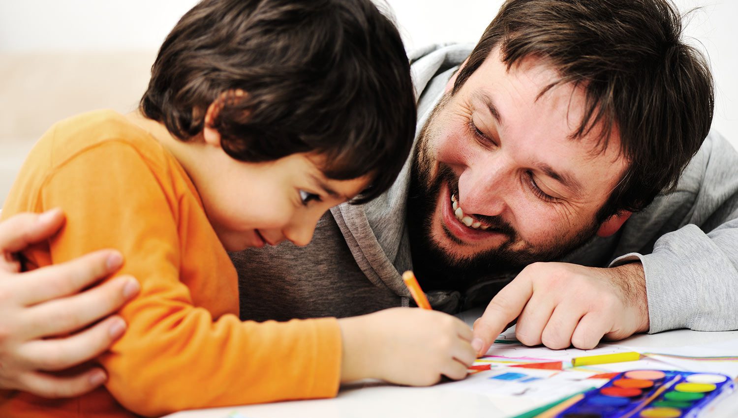 Dad working with child at home