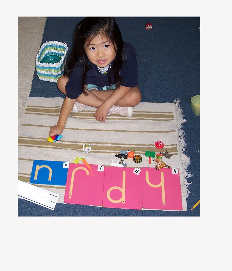 Student playing with letters at Sugar Mill Montessori School