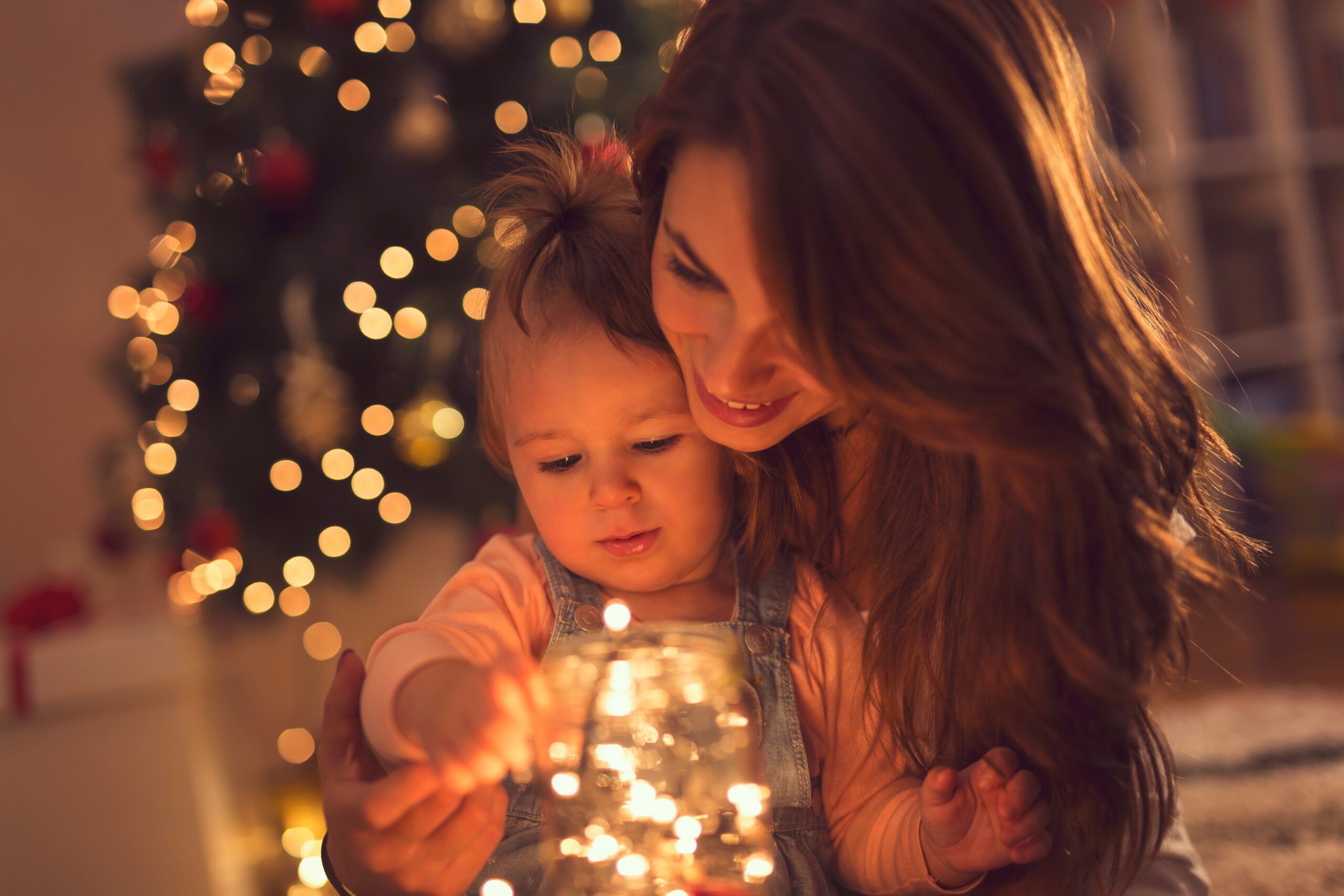 mother and child with holiday lights