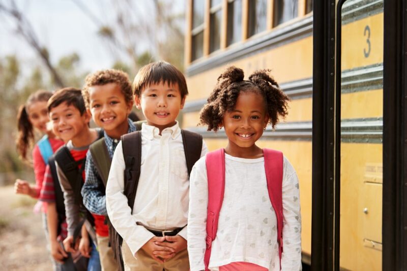 kids lined up at school bus, Adjusting to the New School Year
